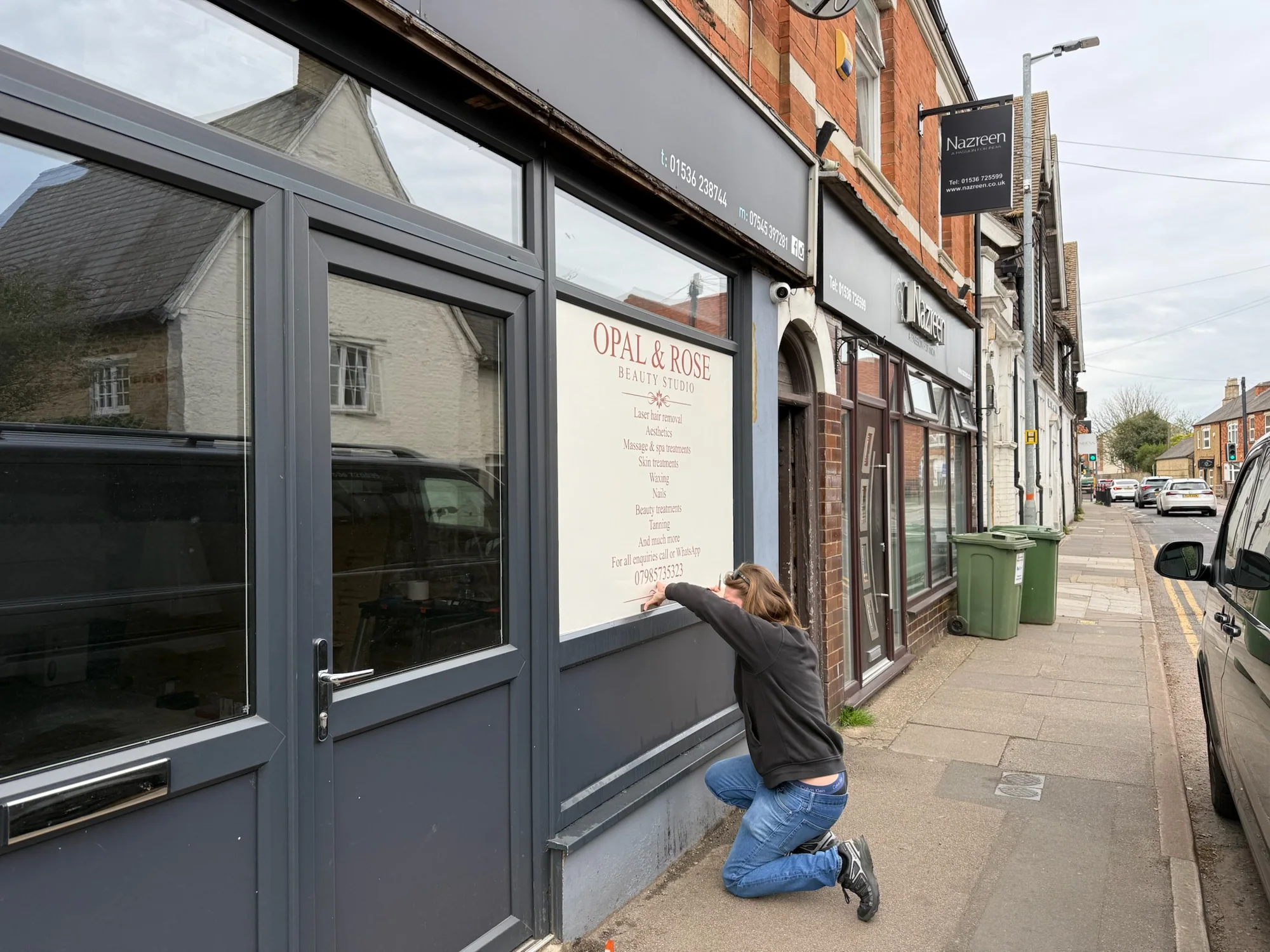 Sign fitter applying an Opal and Rose printed window panel