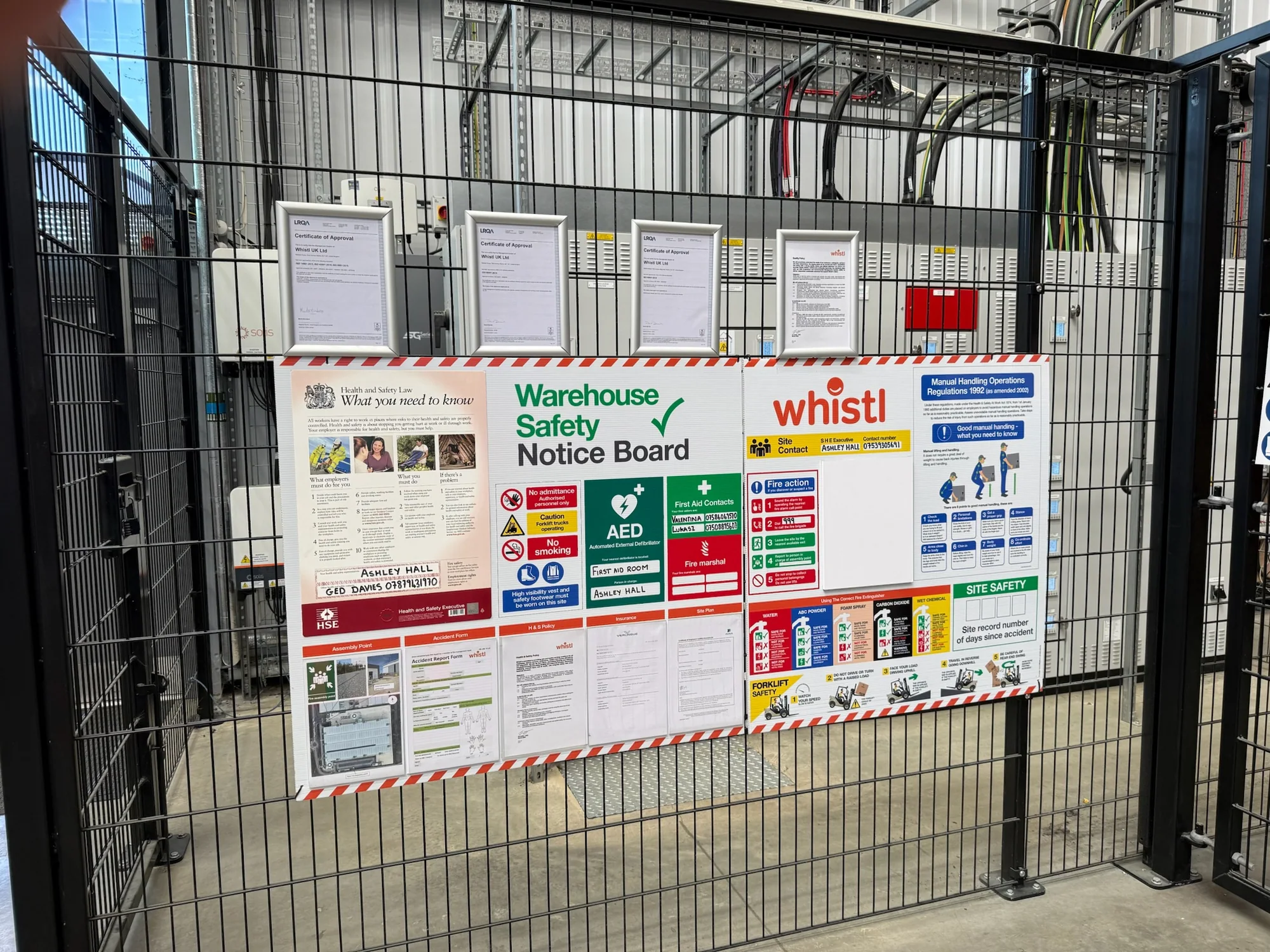 Whistl warehouse safety notice board fixed to a secure mesh gate
